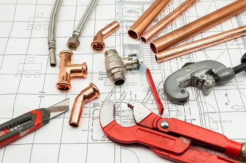 a selection of plumbing tools and copper plumbing pipes used on plumbing installations and repairs